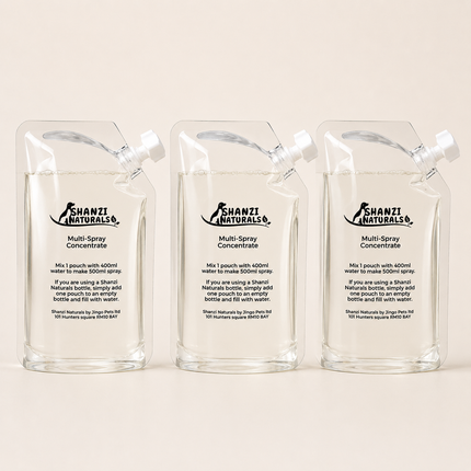 Three clear Shanzi Naturals multi-spray concentrate pouches on a beige background